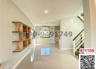 Bright and spacious hallway with stairs and wooden shelves