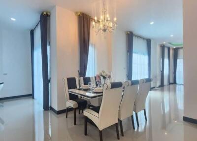 Elegant dining room with chandelier and polished tile flooring