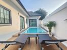 Private swimming pool with adjoining patio and entertainment space featuring table tennis