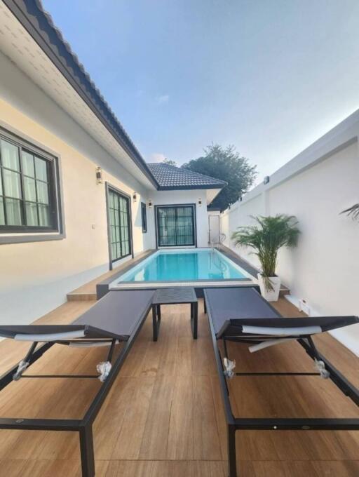 Private swimming pool with adjoining patio and entertainment space featuring table tennis