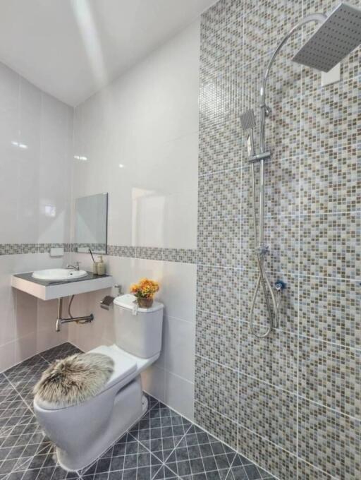 Modern bathroom with mosaic tiles and rain shower