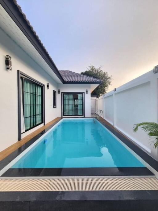 Private swimming pool adjacent to a modern house