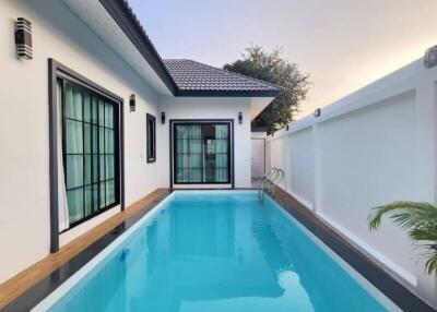 Private swimming pool adjacent to a modern house