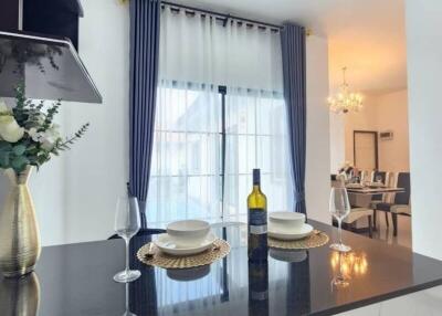 Modern kitchen with a dining area in the background