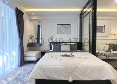 Cozy and stylish modern bedroom with integrated seating area