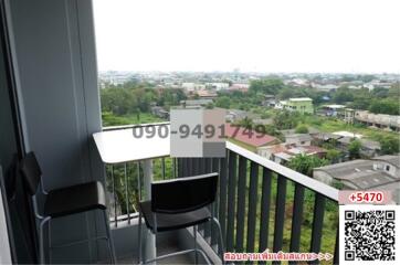 Balcony view overlooking the city with seating area