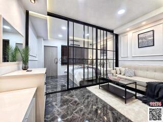 Modern bedroom with glass partition and living area