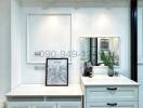 Modern kitchen interior with white cabinetry and marble flooring