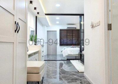 Modern interior design of a building corridor leading to a bedroom with marble flooring