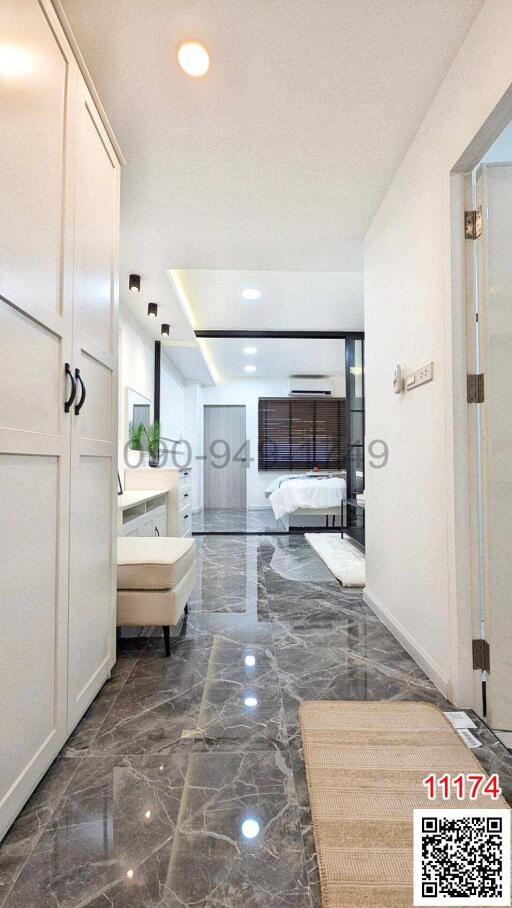 Modern interior design of a building corridor leading to a bedroom with marble flooring