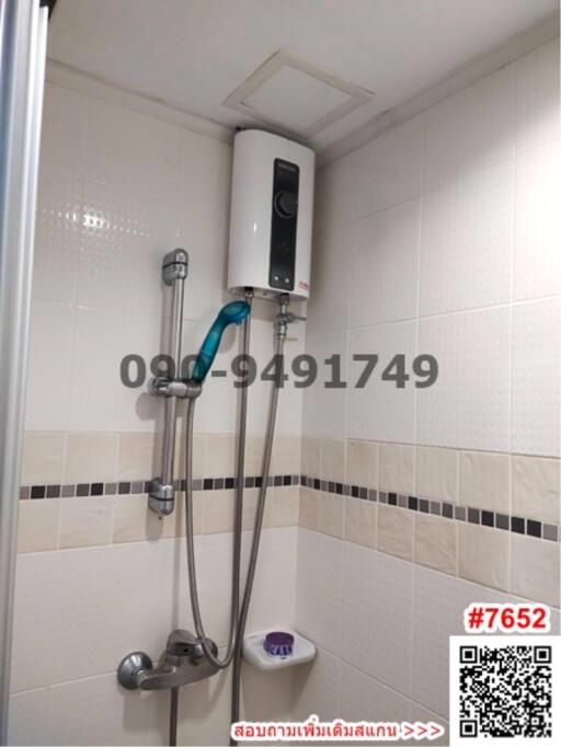 Compact bathroom with wall-mounted shower and water heater