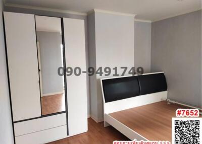 Spacious bedroom with large wardrobe and a modern bed
