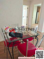 Dining room with glass table and red chairs