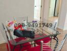 Dining room with glass table and red chairs