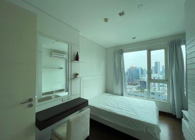 Modern bedroom with city view and natural light