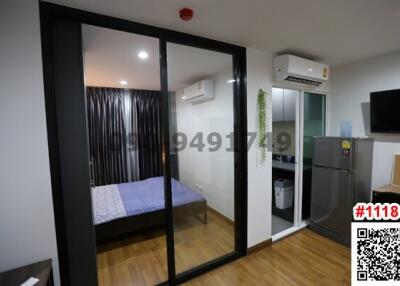 Modern bedroom with sliding glass door and compact kitchenette