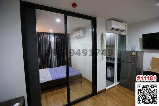 Modern bedroom with sliding glass door and compact kitchenette