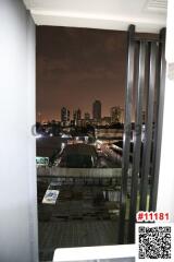 View from the balcony at night showcasing the city skyline