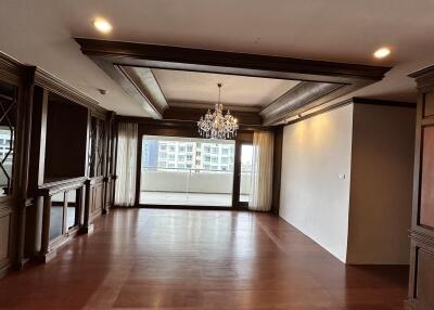 Spacious living room with hardwood floors and a large window