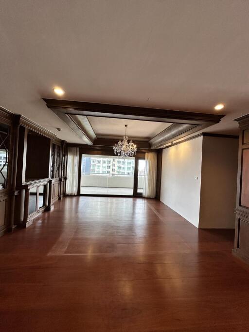 Spacious living room with hardwood floors and a large window