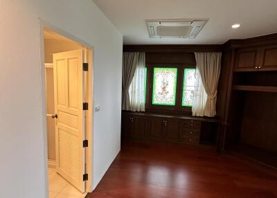 Cozy bedroom with wooden flooring and built-in wardrobe