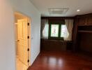 Cozy bedroom with wooden flooring and built-in wardrobe