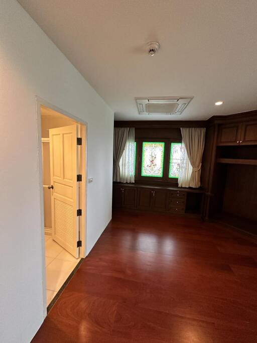 Cozy bedroom with wooden flooring and built-in wardrobe