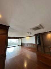 Spacious living room with hardwood floors and natural light