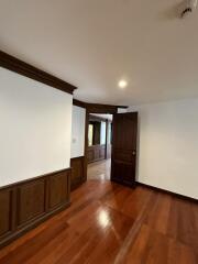 Spacious room with wooden flooring and elegant trim