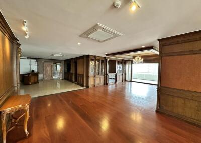 Spacious living room with hardwood flooring and elegant interior woodwork