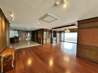 Spacious living room with hardwood flooring and elegant interior woodwork