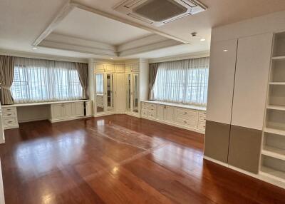 Spacious living room with hardwood floors and ample natural light