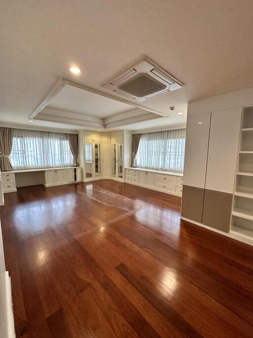 Spacious living room with hardwood floors and ample natural light