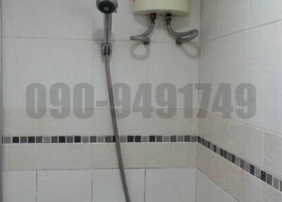 Compact tiled bathroom with electric shower unit