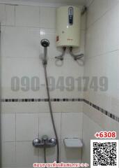 Compact tiled bathroom with electric shower unit