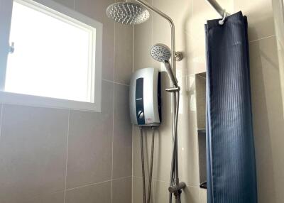 Modern bathroom interior with dual shower heads and natural light