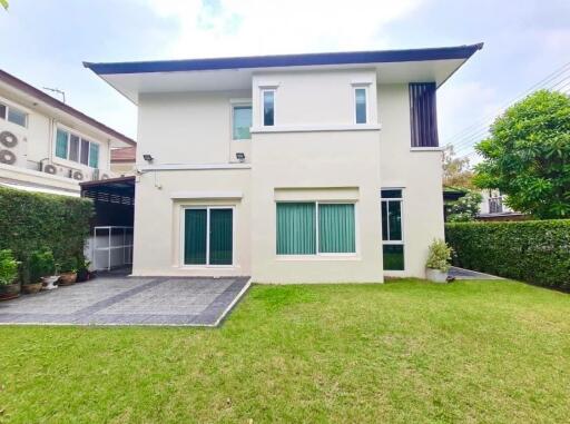 Modern two-story house with a spacious lawn and driveway