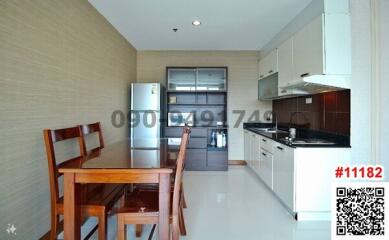 Modern kitchen with wooden dining table and stainless steel appliances