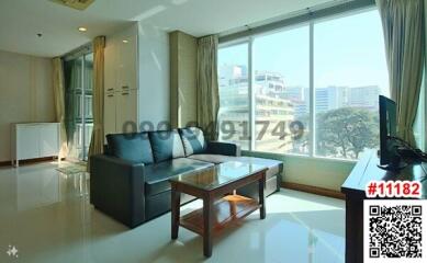 Spacious living room with large windows and natural light