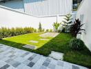 Modern home exterior with landscaped garden and patterned paving