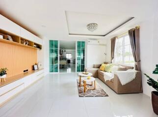 Bright and modern living room with open layout leading to the kitchen