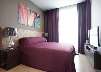 Elegant bedroom with modern furnishings and artwork