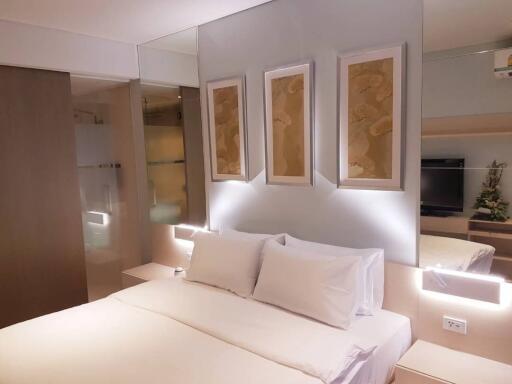 Modern bedroom with ambient lighting and art on the wall
