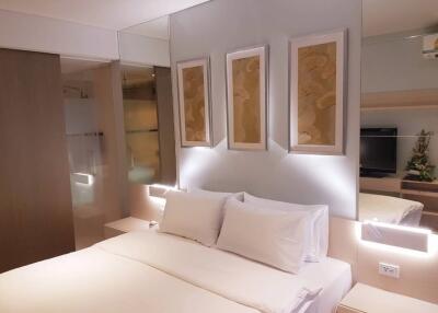 Modern bedroom with ambient lighting and art on the wall