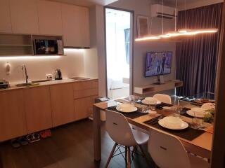 Modern kitchen with adjacent dining table set for a meal