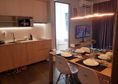 Modern kitchen with adjacent dining table set for a meal
