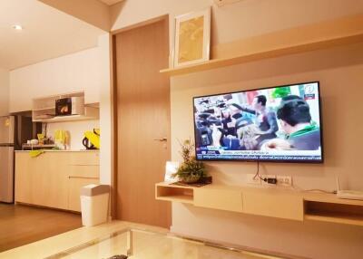 Modern living room interior with mounted television and comfortable seating