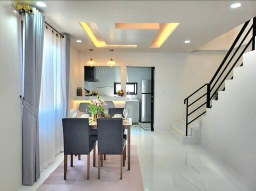 Modern dining area with open kitchen and staircase