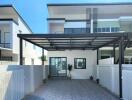 Spacious driveway leading to a modern two-story home with covered parking area