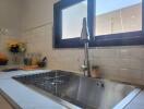 Modern kitchen with stainless steel sink and sunlight